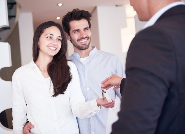 happy couple handed keys